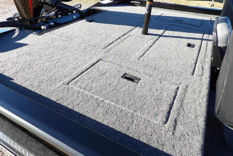 Slide: The Image of 2026 Crestliner XFC 189 boat deck with carpeted storage compartments. - 8