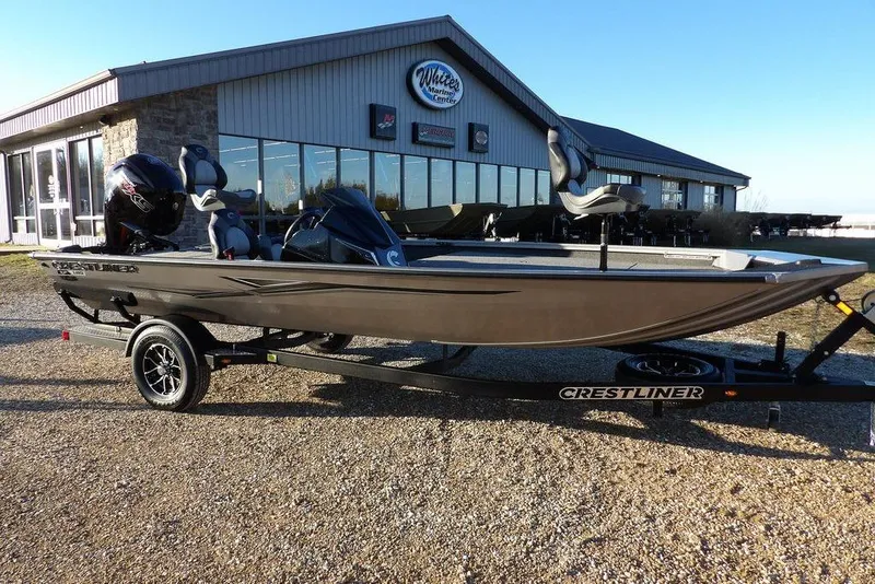 The Image of 2026 Crestliner XFC 189 boat on trailer in front of building. - 0