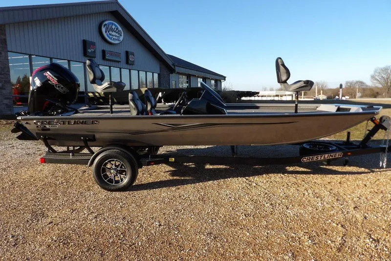 Slide: The Image of 2026 Crestliner XFC 189 boat on trailer in front of building. - 1