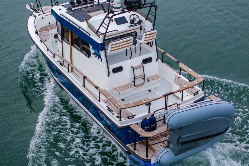 Slide: The Image of 2024 Targa 27.2 boat cruising on water, featuring spacious deck and modern design. - 11