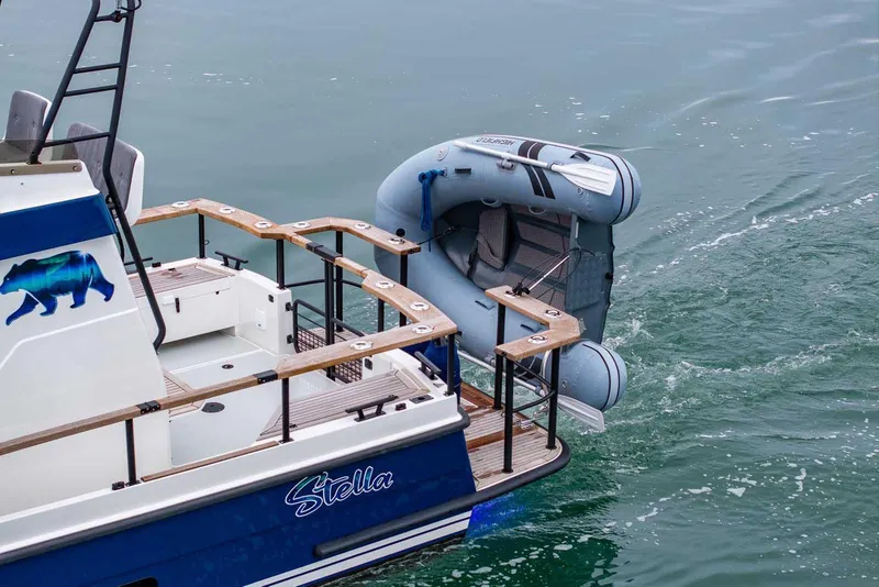 Slide: The Image of 2024 Targa 27.2 boat with inflatable dinghy, featuring a bear graphic and "Stella" name. - 13