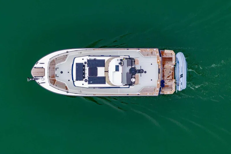 Slide: The Image of Aerial view of 2024 Targa 27.2 boat cruising on green water. - 15