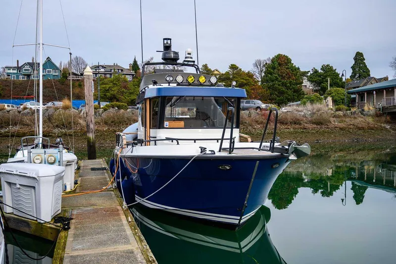 Slide: The Image of 2024 Targa 27.2 boat docked in a serene marina setting. - 16