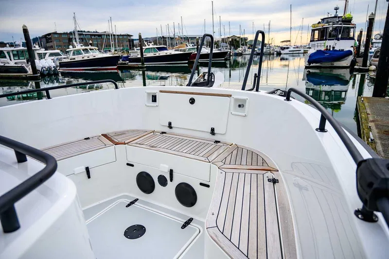 Slide: The Image of 2024 Targa 27.2 boat interior with wooden deck, docked in a marina. - 19