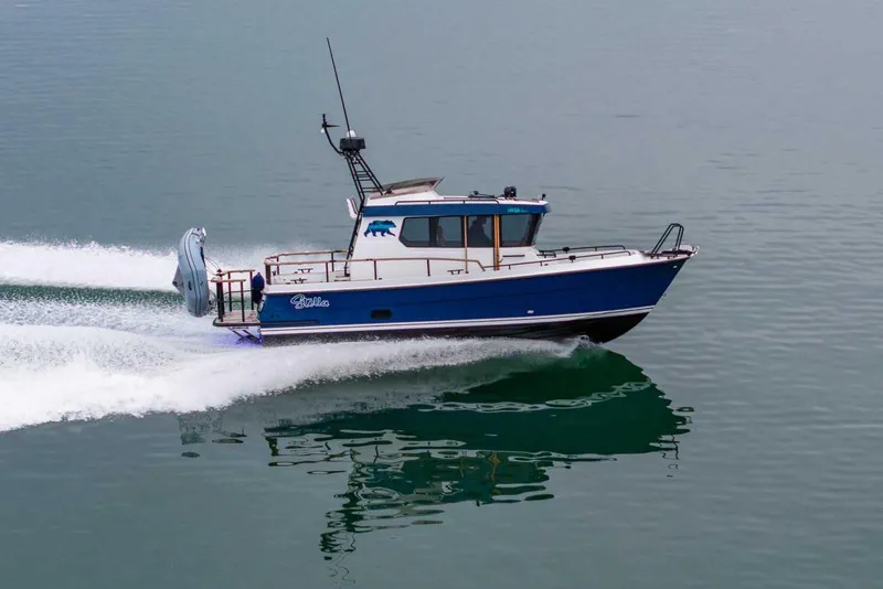 Slide: The Image of 2024 Targa 27.2 boat cruising on calm water, side view. - 2