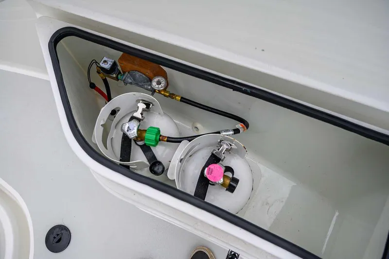 Slide: The Image of Storage compartment with gas cylinders on a 2024 Targa 27.2 boat. - 25