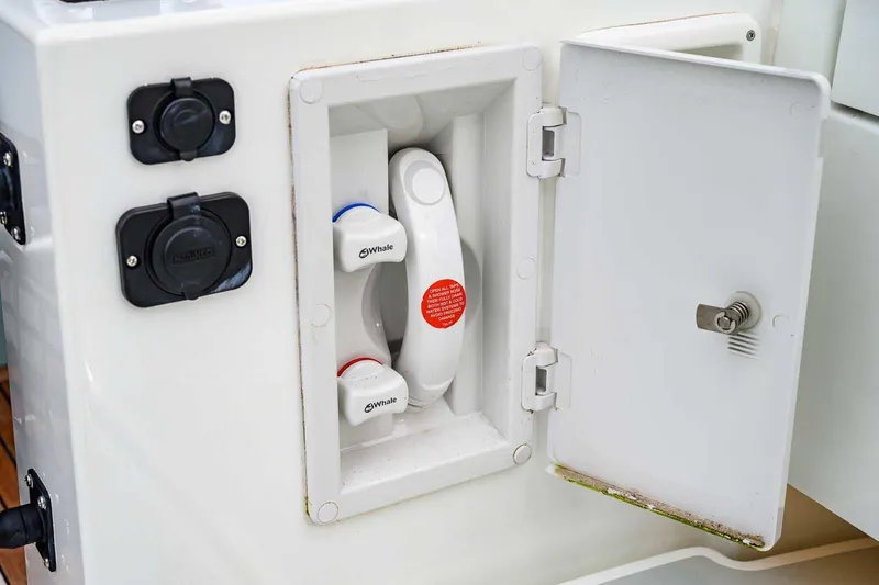 Slide: The Image of 2024 Targa 27.2 boat compartment with Whale water system controls. - 29