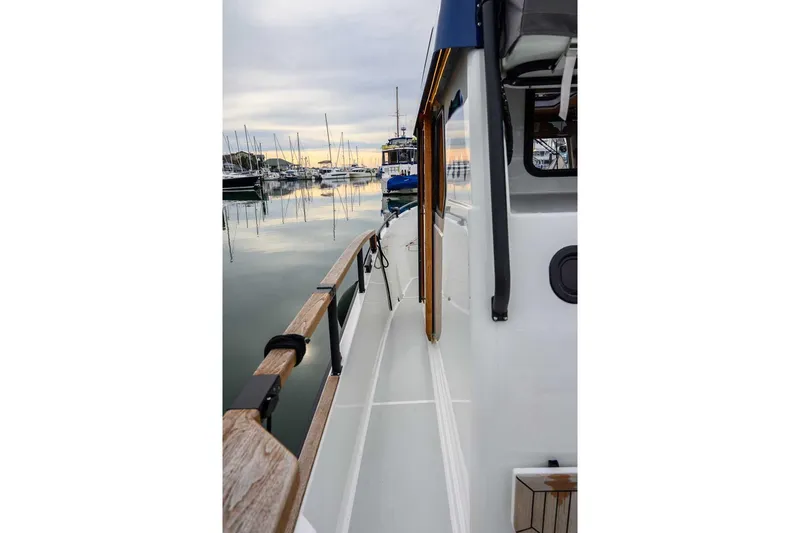 Slide: The Image of 2024 Targa 27.2 boat docked at marina, showcasing sleek design and wooden railings. - 30