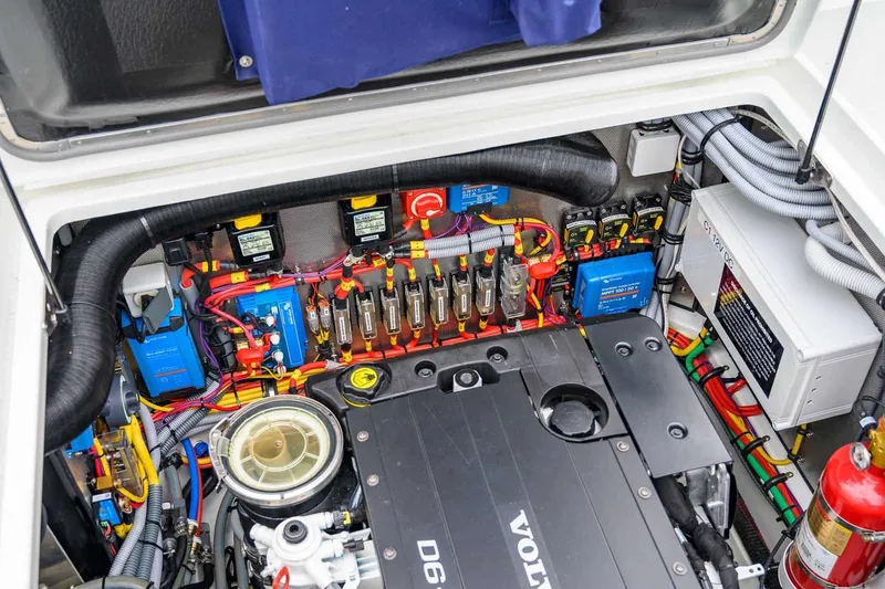 Slide: The Image of Engine compartment of 2024 Targa 27.2 boat, featuring Volvo Penta D6 engine and electrical components. - 35