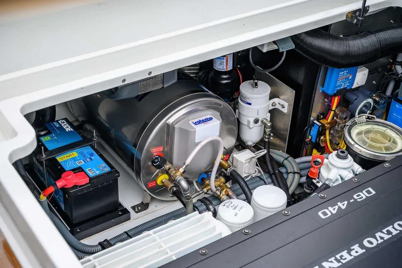 Slide: The Image of Engine compartment of 2024 Targa 27.2 boat, featuring Volvo Penta components and Exide battery. - 38