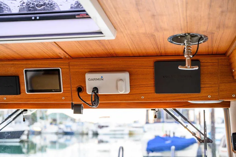 Slide: The Image of 2024 Targa 27.2 boat interior with Garmin navigation system and wooden paneling. - 41