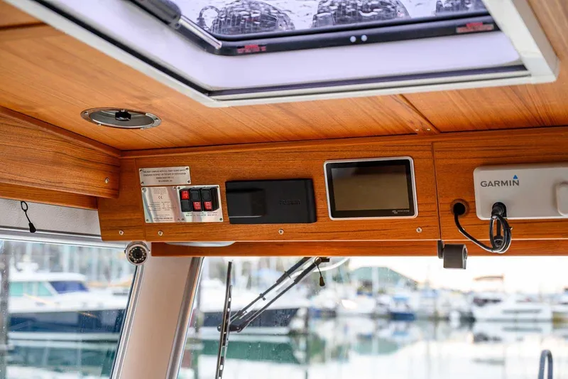 Slide: The Image of 2024 Targa 27.2 boat interior with wooden paneling and navigation equipment. - 42
