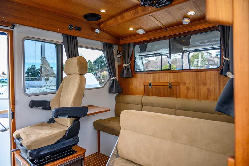 Slide: The Image of 2024 Targa 27.2 boat interior with plush seating and wooden accents. - 46