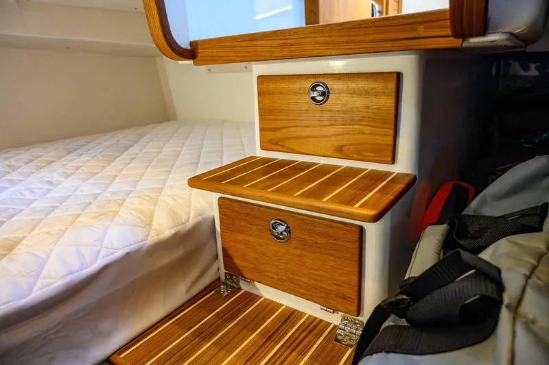 Slide: The Image of 2024 Targa 27.2 cabin interior with wooden steps and cozy bedding. - 51