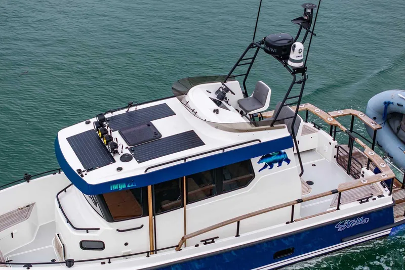 Slide: The Image of 2024 Targa 27.2 boat with upper deck seating, cruising on calm waters. - 7