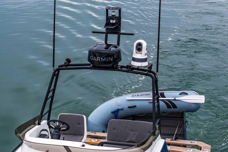 Slide: The Image of 2024 Targa 27.2 boat with Garmin equipment and inflatable dinghy on water. - 8