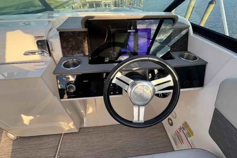 Slide: The Image of 2020 Sea Ray SDX 250 Outboard boat cruising on a sunny waterfront. - 11