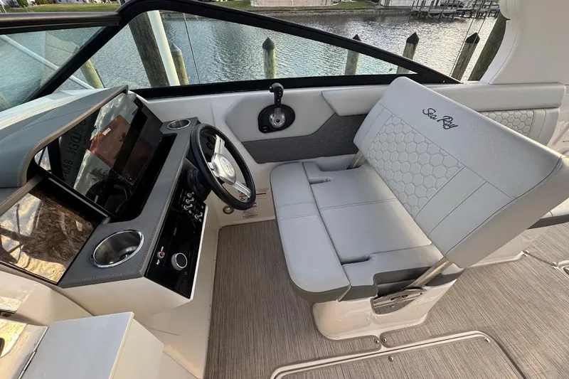 Slide: The Image of 2020 Sea Ray SDX 250 Outboard boat docked, featuring sleek blue and white design. - 15