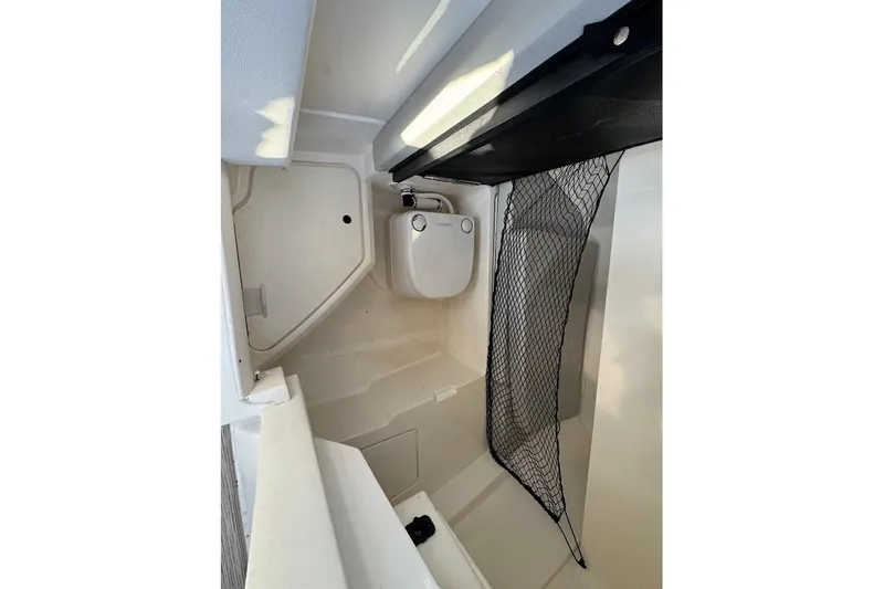 Slide: The Image of 2020 Sea Ray SDX 250 Outboard boat docked on lift, blue and white design. - 16