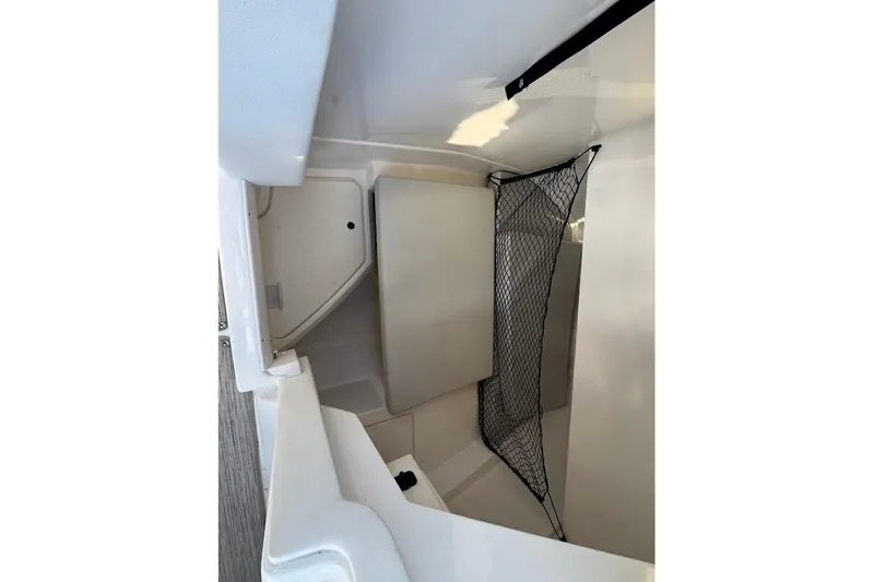 Slide: The Image of 2020 Sea Ray SDX 250 Outboard boat docked on a lift by a waterfront. - 17