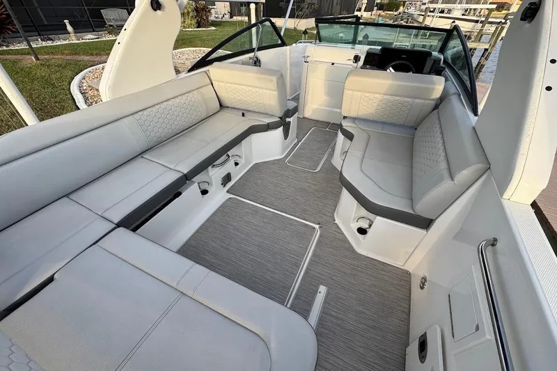 Slide: The Image of 2020 Sea Ray SDX 250 Outboard helm with steering wheel, control panel, and cup holders. - 23