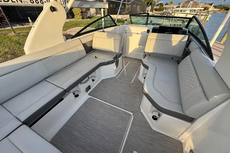 Slide: The Image of 2020 Sea Ray SDX 250 Outboard boat interior with luxurious seating and waterfront view. - 25
