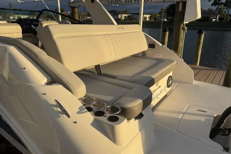 Slide: The Image of 2020 Sea Ray SDX 250 Outboard interior with compact toilet and storage net. - 28