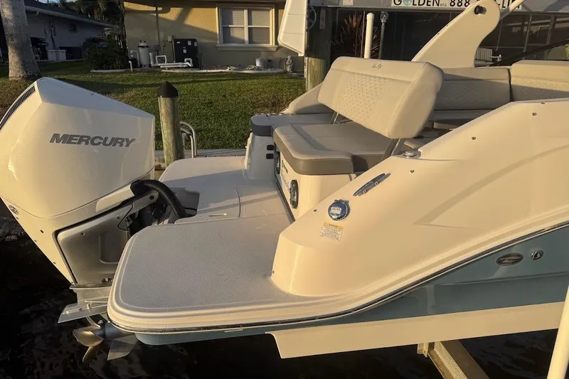 Slide: The Image of 2020 Sea Ray SDX 250 Outboard boat interior with cushioned seating and textured flooring. - 31
