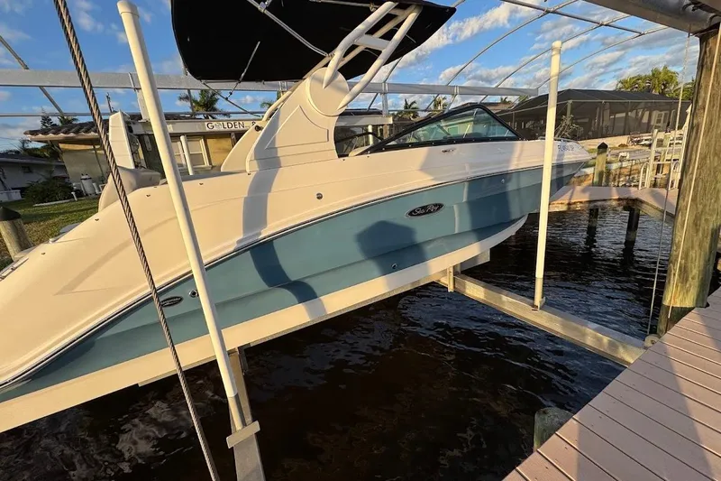 Slide: The Image of 2020 Sea Ray SDX 250 Outboard boat interior with white cushioned seating. - 33