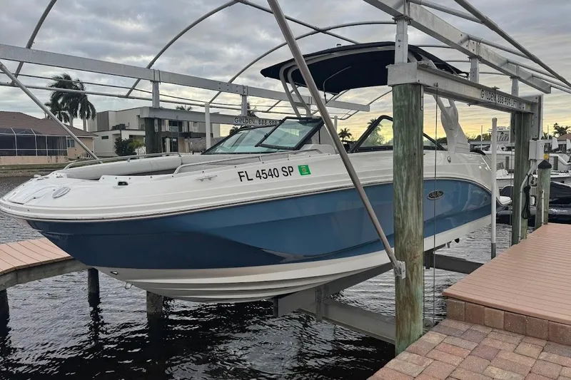 Slide: The Image of 2020 Sea Ray SDX 250 Outboard boat cruising on a sunny waterway. - 4