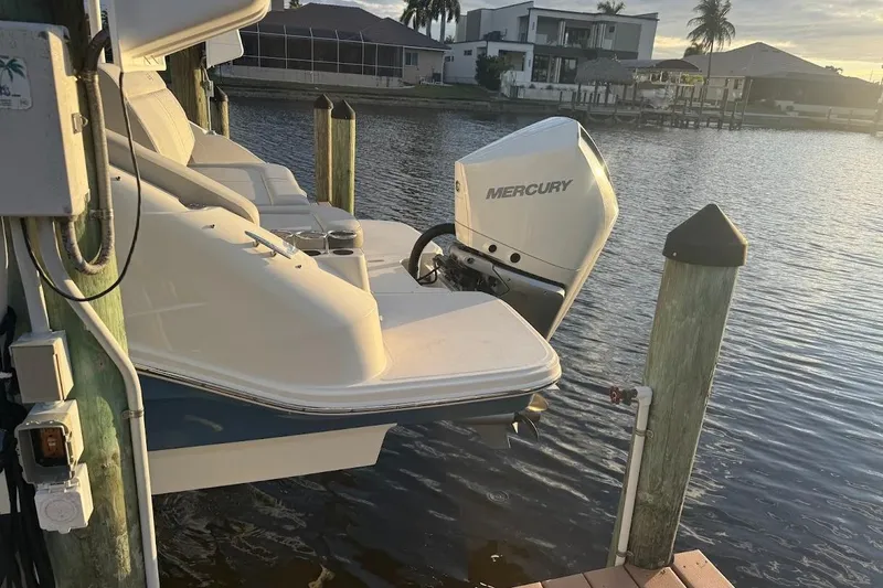 Slide: The Image of 2020 Sea Ray SDX 250 Outboard docked by waterfront homes at sunset. - 42