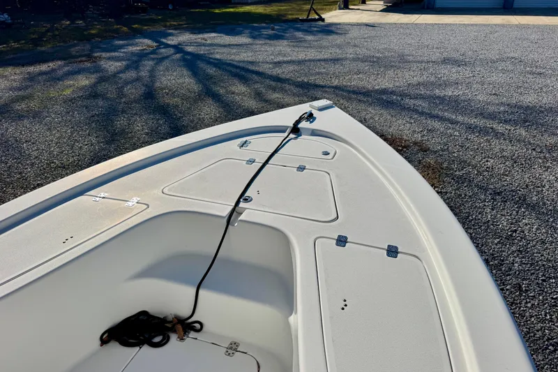 Slide: The Image of 2018 Sea Pro 208 Bay boat deck with storage compartments and rope. - 5