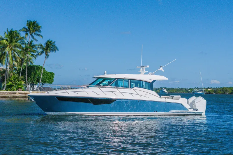 The Image of 2025 Tiara Yachts 43 LE cruising on a sunny day with palm trees in the background. - 0