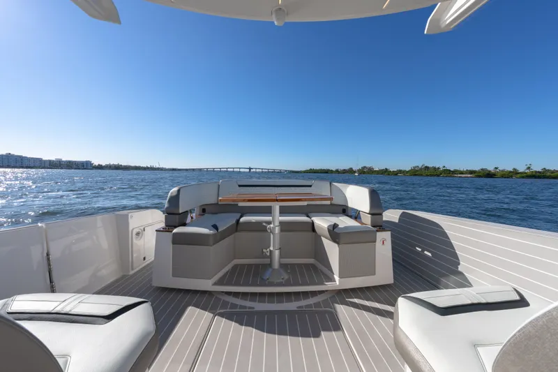 Slide: The Image of 2025 Tiara Yachts 43 LE deck with seating, table, and scenic water view. - 12