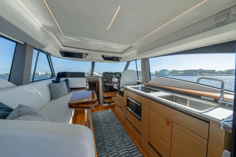 Slide: The Image of Luxurious interior of 2025 Tiara Yachts 43 LE with modern kitchen and seating area. - 14