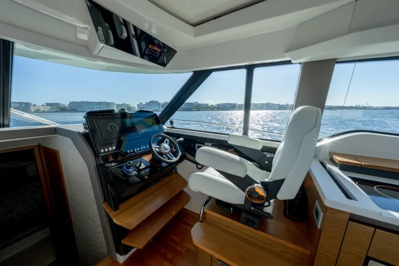 Slide: The Image of 2025 Tiara Yachts 43 LE helm with modern controls and panoramic water view. - 19