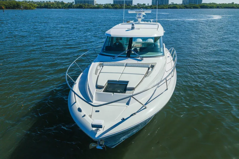 Slide: The Image of 2025 Tiara Yachts 43 LE cruising on a serene blue lake. - 2