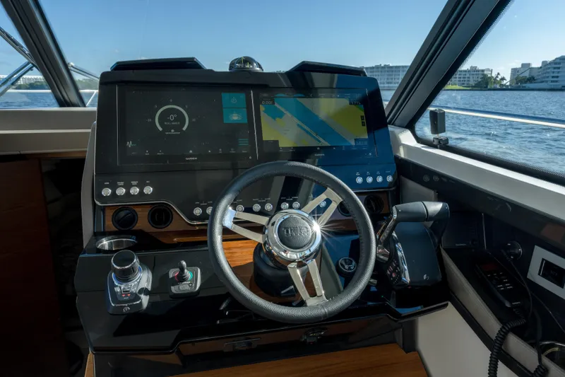 Slide: The Image of 2025 Tiara Yachts 43 LE helm with advanced navigation displays and controls. - 21
