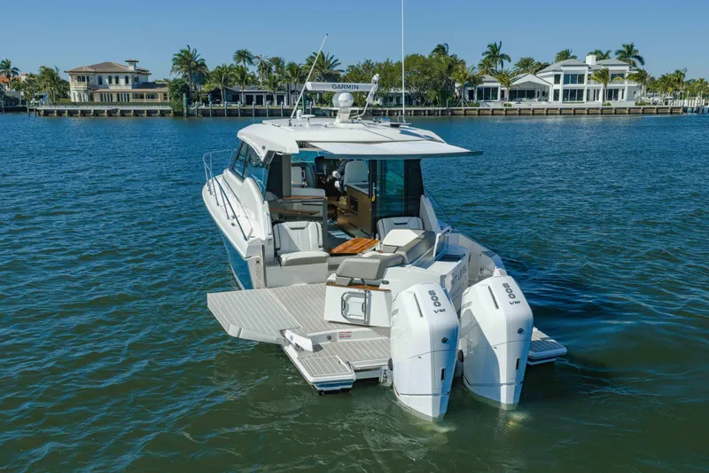 Slide: The Image of 2025 Tiara Yachts 43 LE luxury boat on serene water with scenic background. - 3