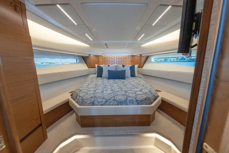 Slide: The Image of Luxurious 2025 Tiara Yachts 43 LE cabin interior with elegant bedding and modern design. - 31