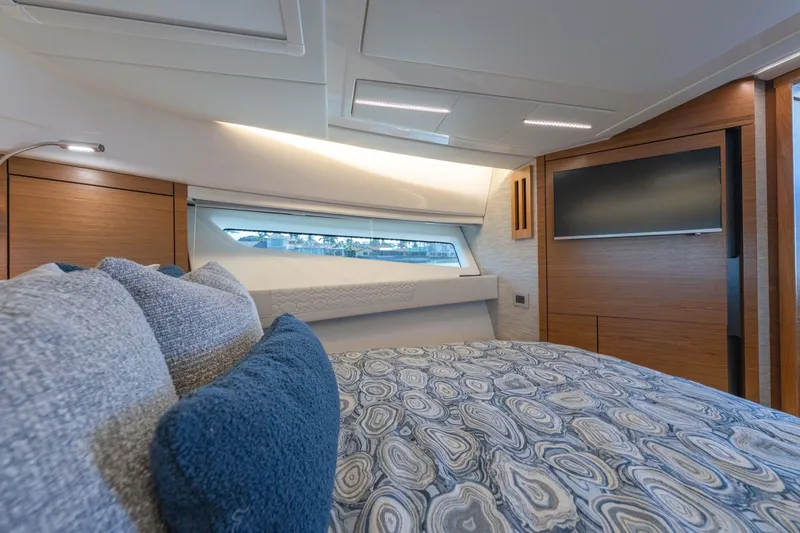 Slide: The Image of Luxurious interior of 2025 Tiara Yachts 43 LE, featuring elegant bedding and modern design. - 34
