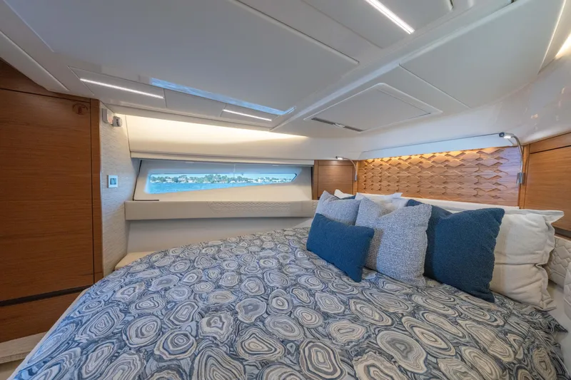 Slide: The Image of Luxurious 2025 Tiara Yachts 43 LE cabin interior with elegant bedding and modern design. - 36
