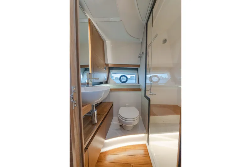 Slide: The Image of Luxurious bathroom interior of 2025 Tiara Yachts 43 LE, featuring modern fixtures and wood accents. - 37