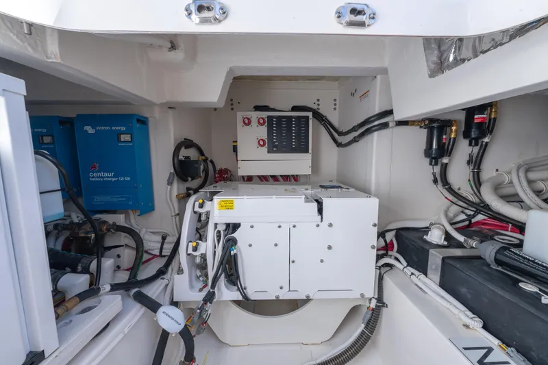 Slide: The Image of Engine room of 2025 Tiara Yachts 43 LE, featuring advanced electrical systems and components. - 46