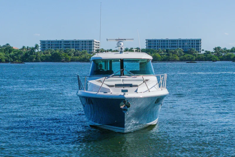 Slide: The Image of 2025 Tiara Yachts 43 LE cruising on a sunny day with buildings in the background. - 48