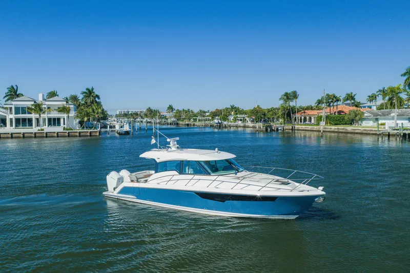 Slide: The Image of 2025 Tiara Yachts 43 LE cruising in a scenic waterfront setting. - 49