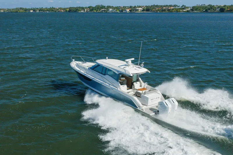 Slide: The Image of 2025 Tiara Yachts 43 LE cruising on open water, showcasing sleek design and powerful performance. - 53