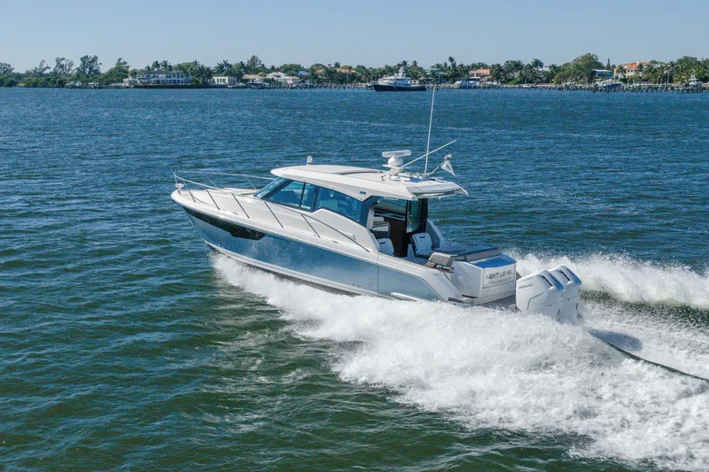 Slide: The Image of 2025 Tiara Yachts 43 LE cruising on open water, showcasing sleek design and powerful engines. - 55