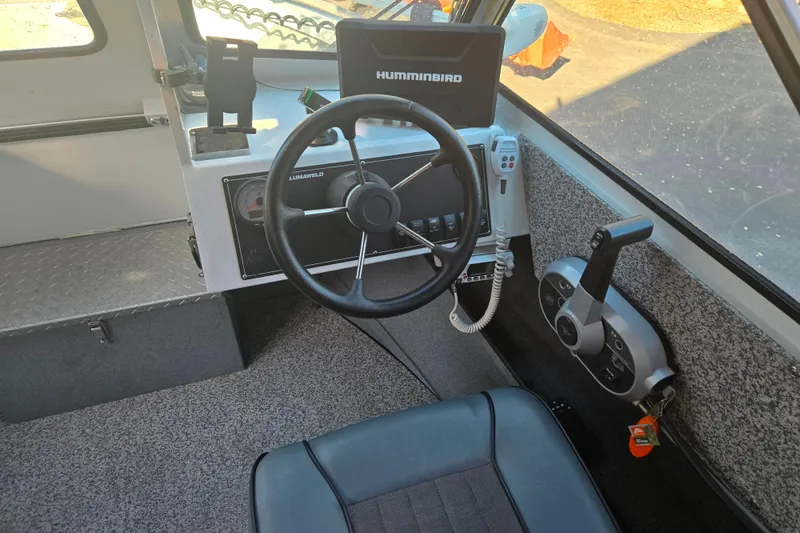 Slide: The Image of 2021 Alumaweld Intruder Outboard 20 boat cockpit with steering wheel and Humminbird electronics. - 10