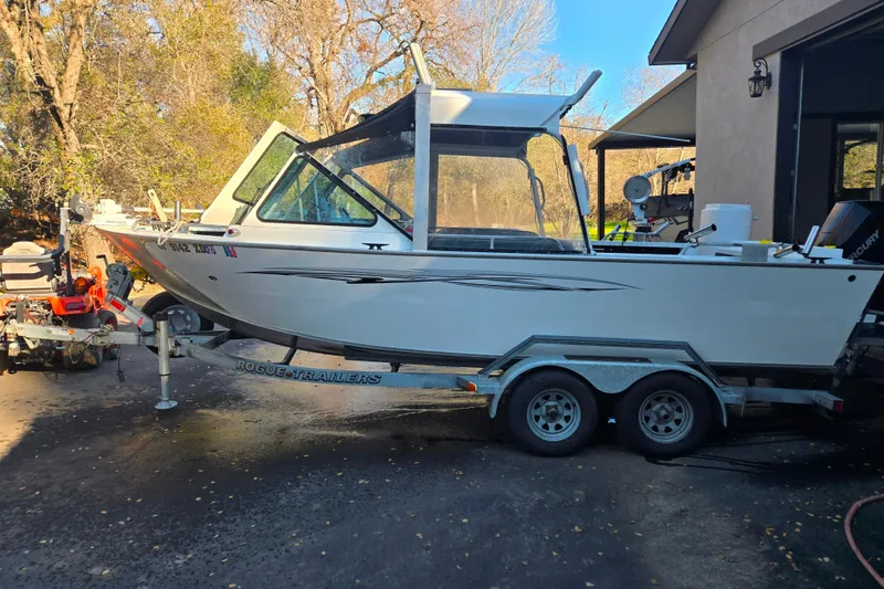 Slide: The Image of 2021 Alumaweld Intruder Outboard 20 boat on trailer, parked outdoors. - 13